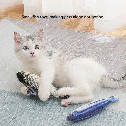 White and grey kitten biting a realistic fish toy on a rug beside a blue sardine toy, text reads small fish toys making pets alone not boring