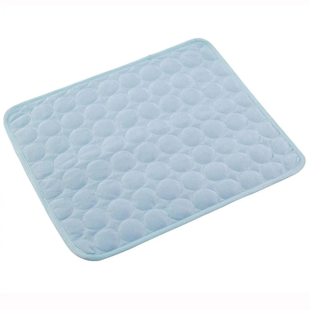 Pale blue quilted cooling gel mat laid flat, angled studio shot on white background