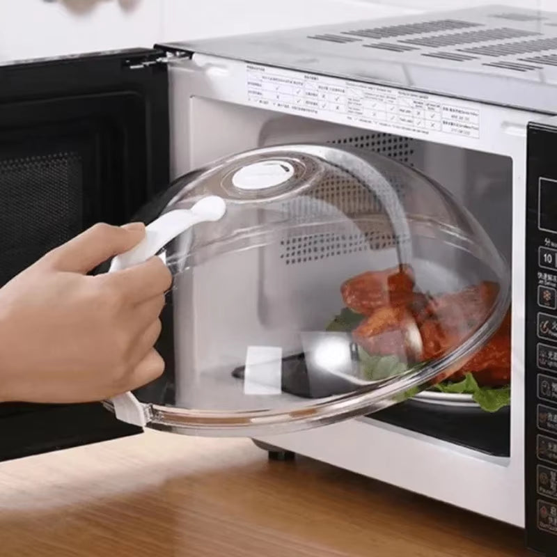 Hand opening the splash guard over a plate of food inside a microwave with digital display and lettuce garnish visible