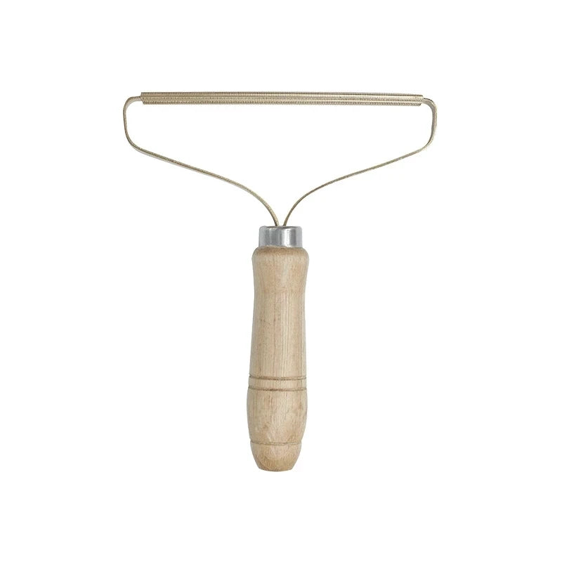 Wooden-handled wire-loop lint comb alone on white background, front view