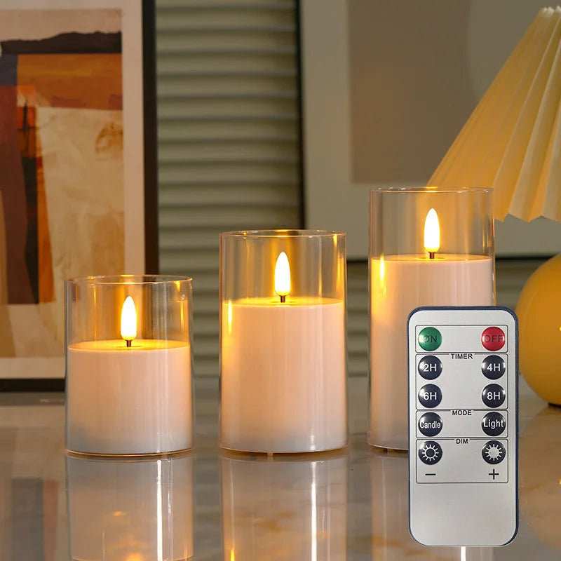 Three clear glass LED candles on a marble table with wall art and a lamp in a living room setting