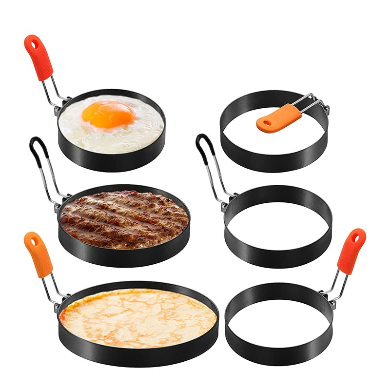 Set of egg rings in use on a griddle with a fried egg, burger patty, and pancake, plus three empty rings