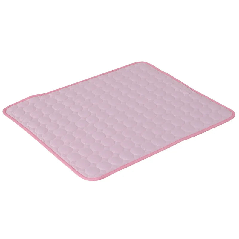 Pink quilted cooling gel mat laid flat, angled studio shot on white background