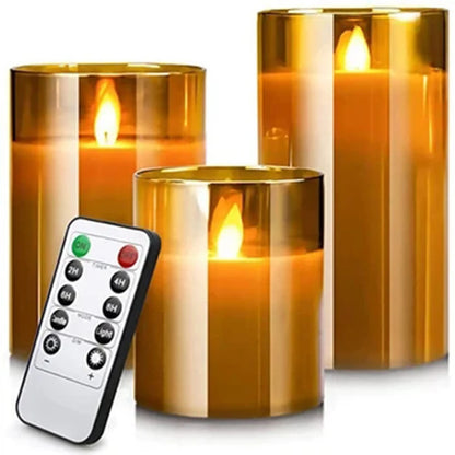 Three amber glass flameless LED candles with flickering flame and remote control, on white background