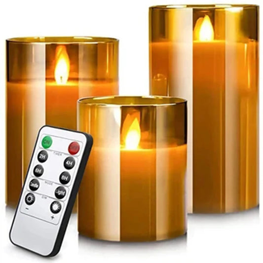 Three amber glass flameless LED candles with flickering flame and remote control, on white background