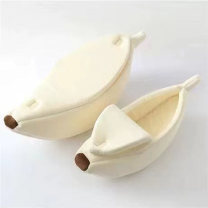 Two cream-colored banana cat beds, one closed and one open showing the interior lining, on white background