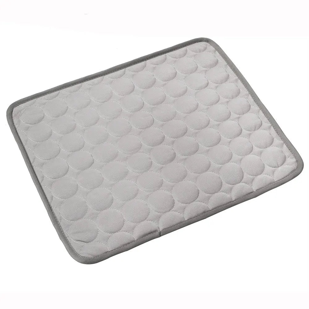 Grey quilted cooling gel mat laid flat, angled studio shot on white background