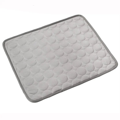Grey quilted cooling gel mat laid flat, angled studio shot on white background