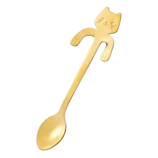 Gold stainless steel cat-shaped spoon shown diagonally on a white background