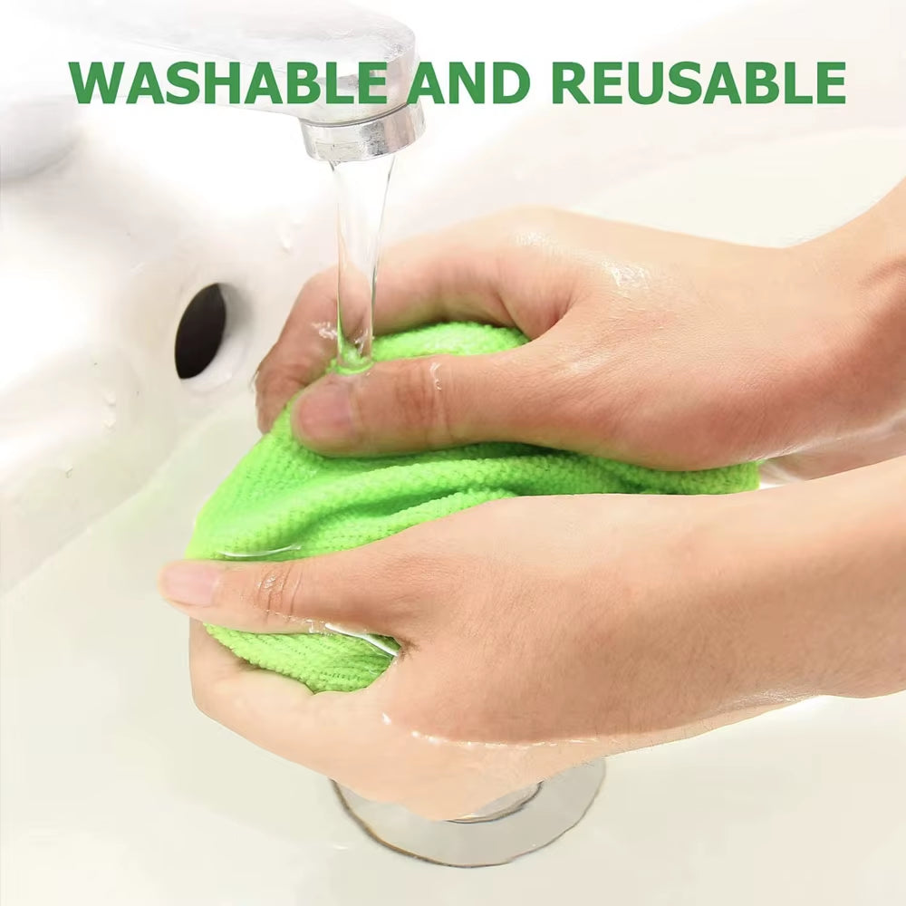 Green microfiber pad being rinsed clean under a running bathroom tap by two hands