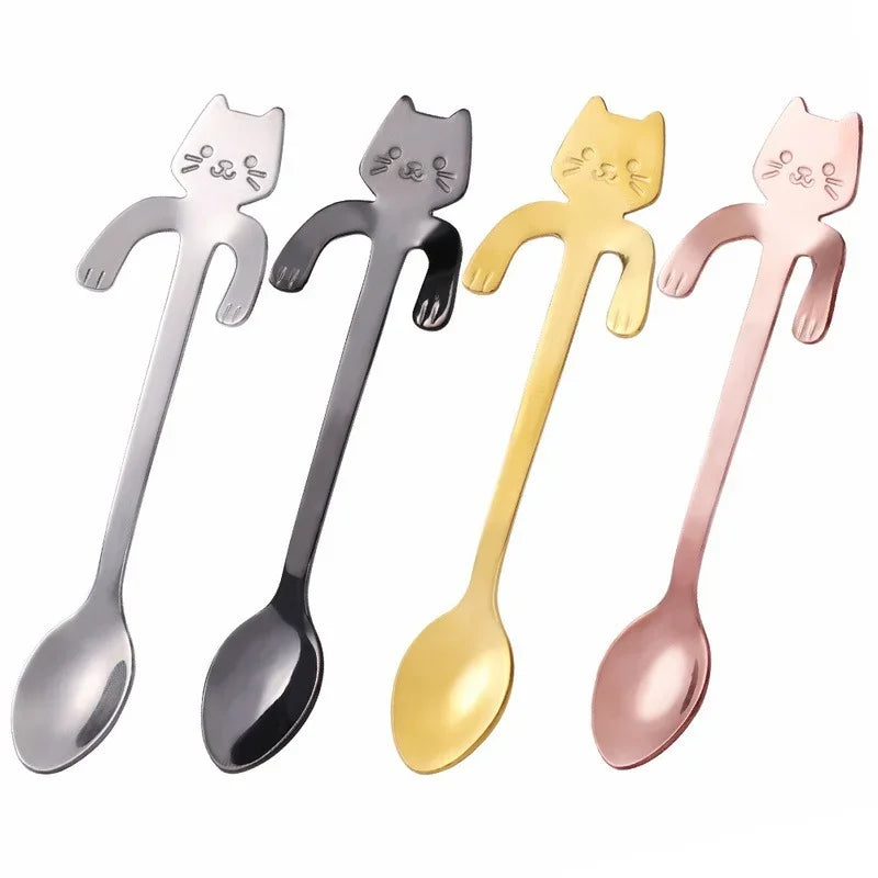 Four cat spoons in a row - silver, gunmetal, gold, and rose gold - shown side by side