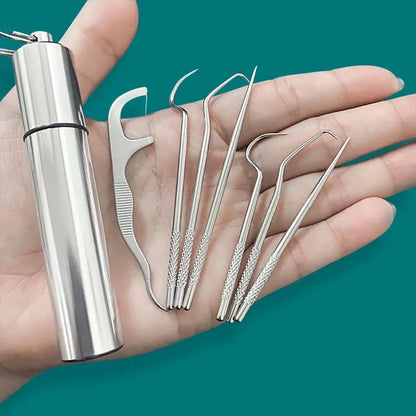 Hand holding the stainless steel toothpick case beside seven pick tools fanned across the palm, teal background