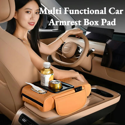 Woman driving with hand resting on tan quilted armrest cushion holding a drink bottle and can