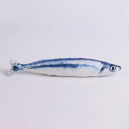 Realistic blue and white sardine-print plush fish toy, side view on white background