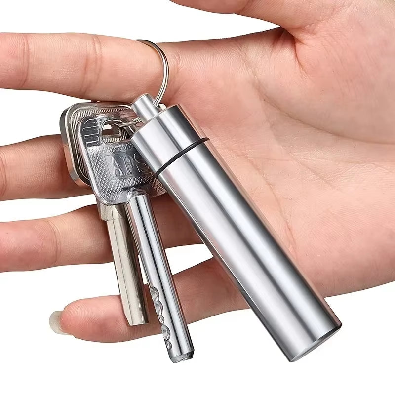 Close-up of a hand holding keys with the stainless steel toothpick case attached to the key ring