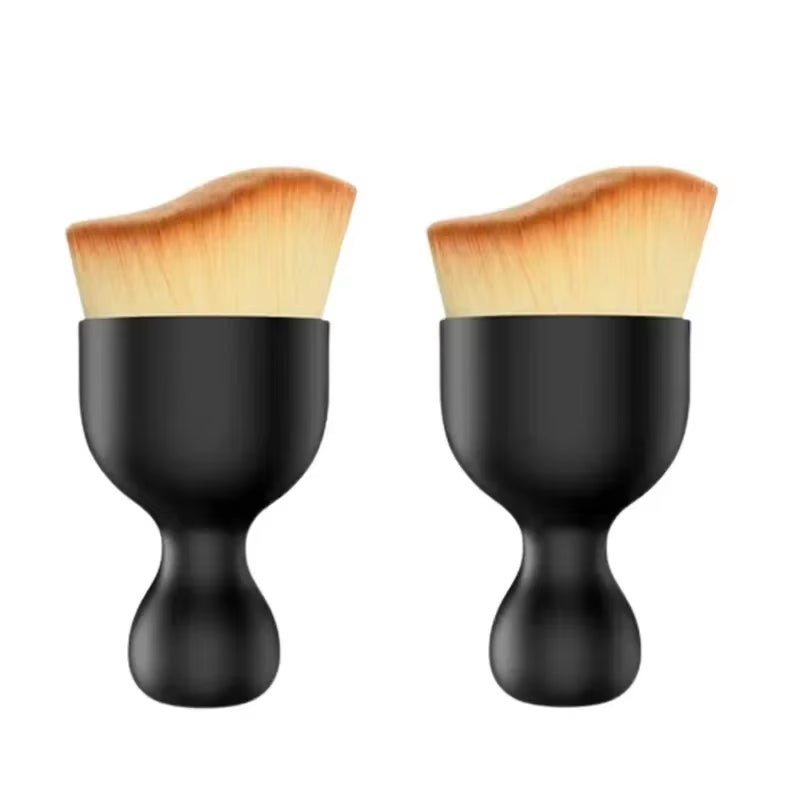 Two detail brushes side by side with black handles and tan bristles on white background