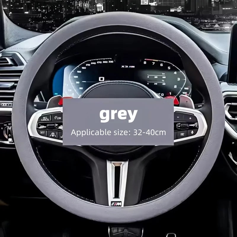 Grey silicone cover fitted on a steering wheel with a city skyline reflected in the windshield behind