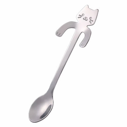 Silver cat-shaped spoon shown diagonally on a white background