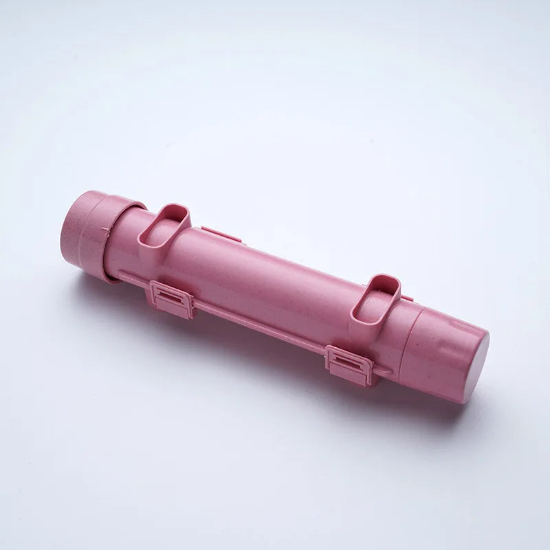 Pink sushi-rolling tube device shown diagonally on a white background