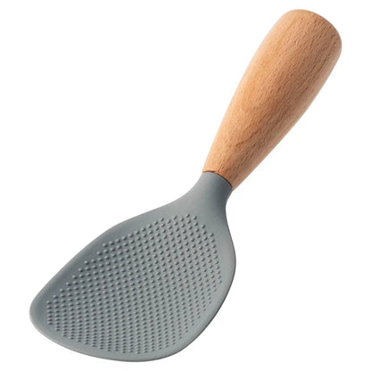Gray silicone rice paddle with beech wood handle, angled studio shot on white background