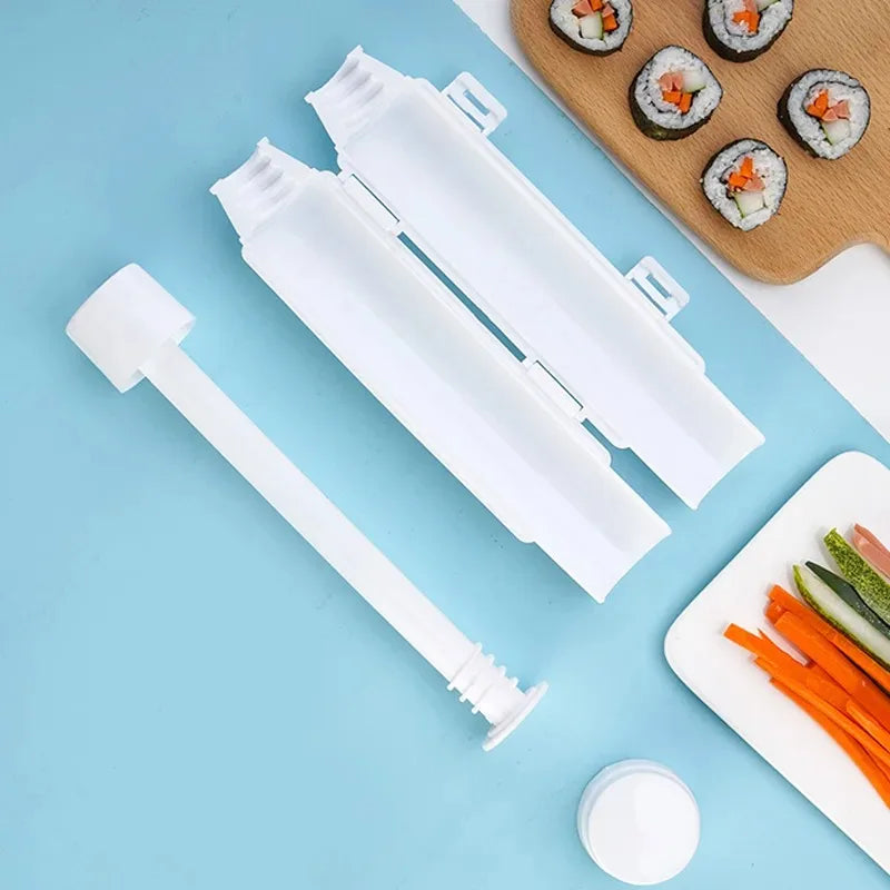 Two disassembled white sushi tubes with the plunger piece, next to sushi rolls and cut vegetables on a blue background
