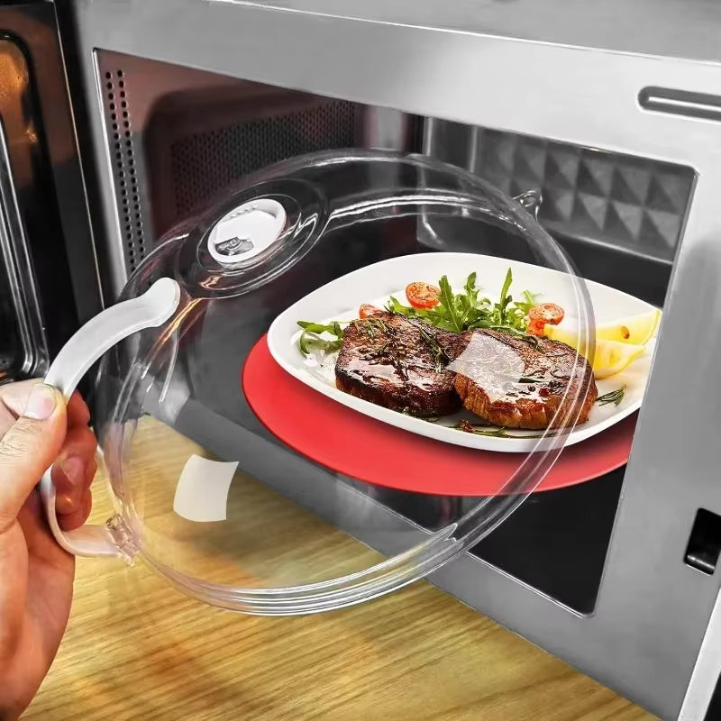 Hand lifting the splash guard off a white plate of grilled steak, arugula and tomatoes inside a microwave