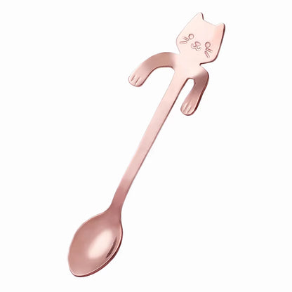 Rose gold cat-shaped spoon shown diagonally on a white background